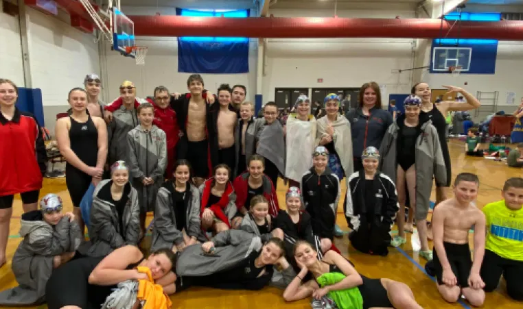 Members of the DCY swim team relax in the gym during a recent swim meet